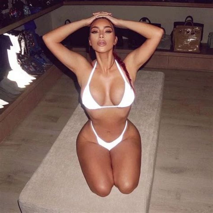 Kim Kardashian Puts Her Curves On Full Display In Two-Piece, Reflective Bathing Suit