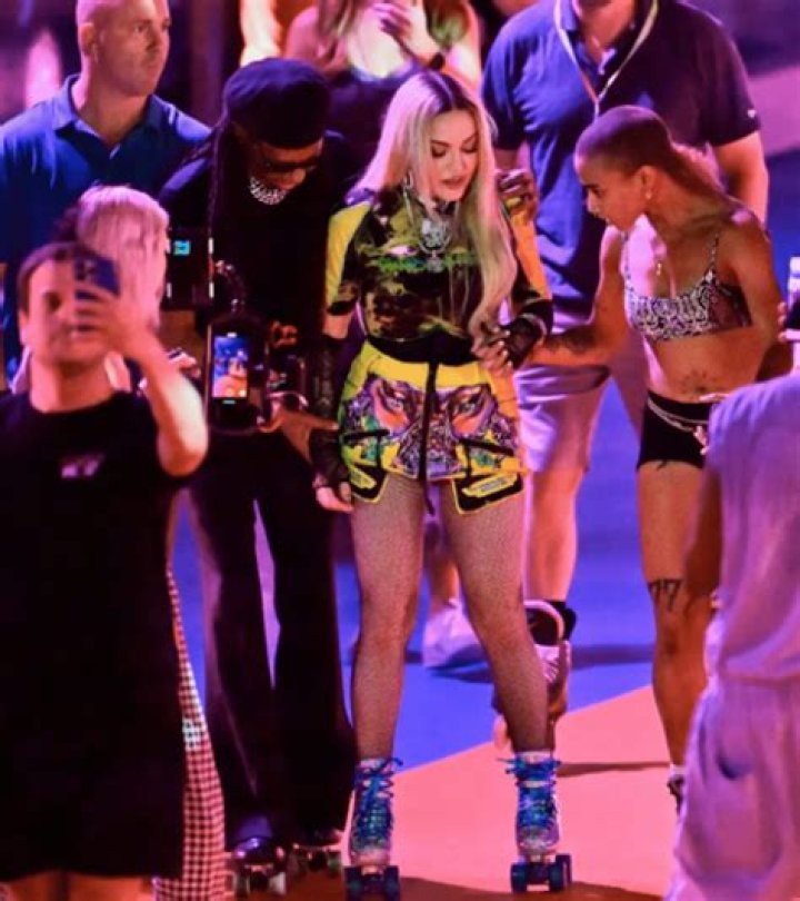 Madonna Skates On A Rollerblade While Surrounded By People To Avoid Falling