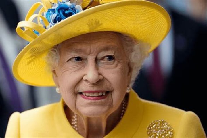Queen Elizabeth II in an elegant sun-colored coat at the unveiling of a metro line in her honor